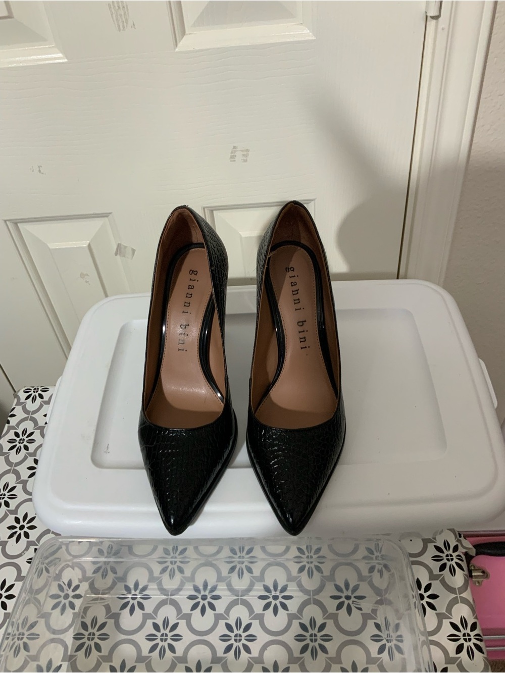 Gianni Bini black textured block heel pumps with a pointed toe.